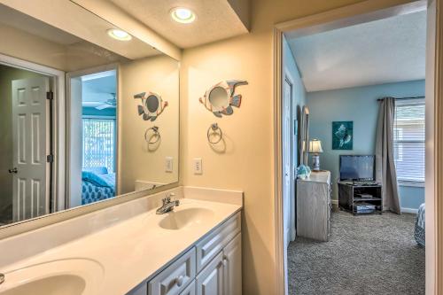 a bathroom with a sink and a mirror at Walk to Beach North Myrtle Condo! in Myrtle Beach