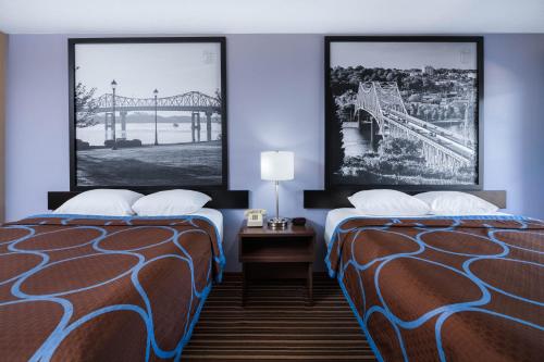 a hotel room with two beds and a roller coaster at Super 8 by Wyndham Gadsden AL in Gadsden