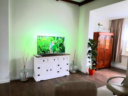 a living room with a flat screen tv on a white cabinet at Villa Meeresglück in Sassnitz