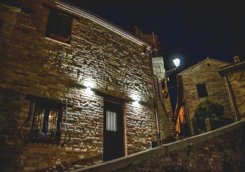 a brick building at night with a light on it at Villa Schinoppi in Amandola
