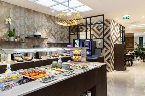 a buffet line with food on display in a restaurant at Best Western Plus Hôtel Massena Nice in Nice