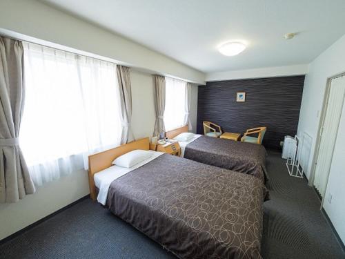 Кровать или кровати в номере Hotel Shin Osaka / Vacation STAY 81527