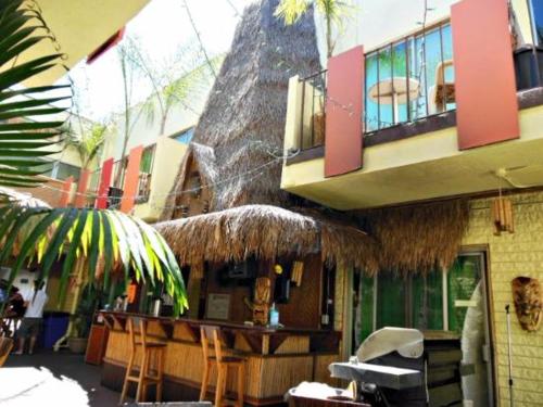 a restaurant with a balcony and a table and chairs at Banana Bungalow West Hollywood Hotel & Hostel in Los Angeles