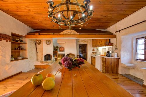 a kitchen with a wooden table with fruit on it at Casa do Castelo em Arnóia in Celorico de Basto