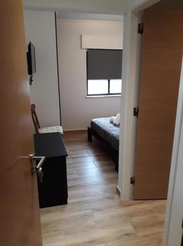 a room with a bed and a desk and a window at "A Casa dos Avôs" Suites & Breakfast in Lagos