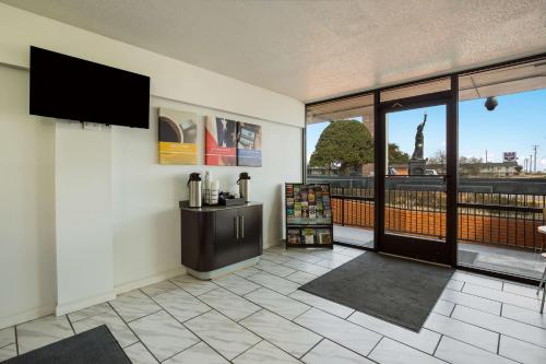 a lobby with a view of the statue of liberty at Studio 6-Temple, TX in Temple