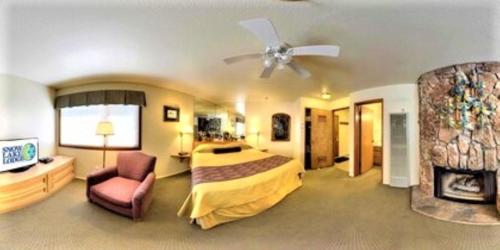 a hotel room with a bed and a ceiling fan at Snow Lake Lodge in Big Bear Lake