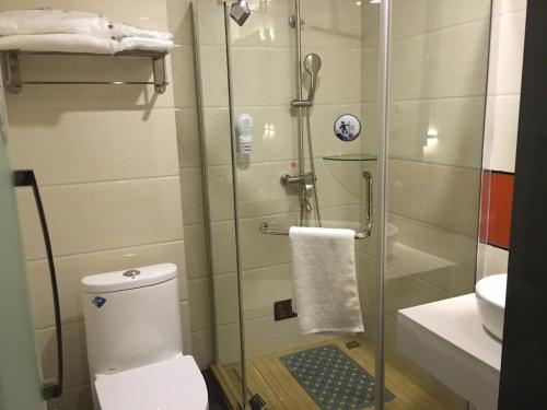 a bathroom with a shower with a toilet and a sink at 7Days Premium Huanggang Walking Street Branch in Huanggang