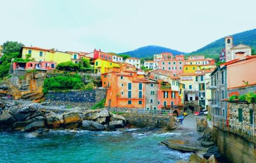 a group of colorful buildings next to a river at Apartments Tellaro in Tellaro
