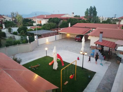 a view of a backyard with a playground at Rea's House Vrachati in Vrahati