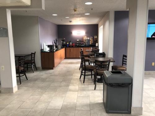 a dining room with tables and chairs in a restaurant at Microtel Inn & Suites by Wyndham Pittsburgh Airport in Robinson Township