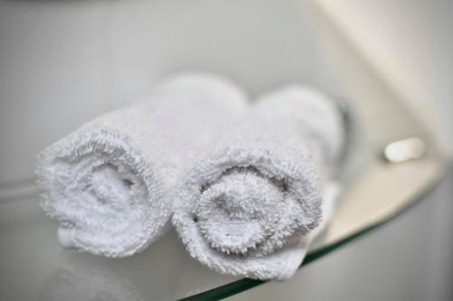 a roll of toilet paper sitting on top of a mirror at Witchingham B&B in Holyhead