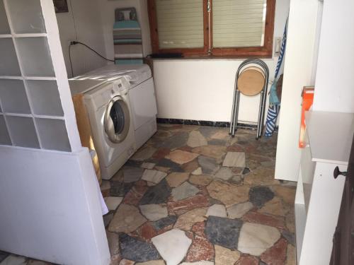 a washer and dryer in a room with a tile floor at Casa Rural Molera in Elda