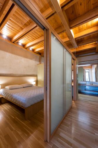 a bedroom with a bed in a room with wooden ceilings at Polixeny's Suites in Chania Town