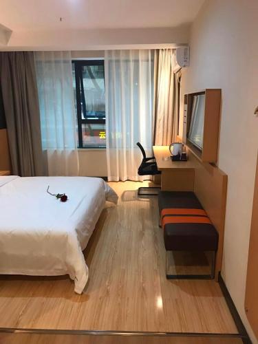 a hotel room with a large bed and a television at 7 Days Premium Chongqing Jiangbei International Airport Branch in Chongqing