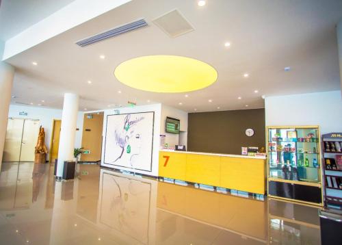 a lobby with a large screen in a store at 7Days Premium Yantai Penglai New Bus Station Branch in Penglai
