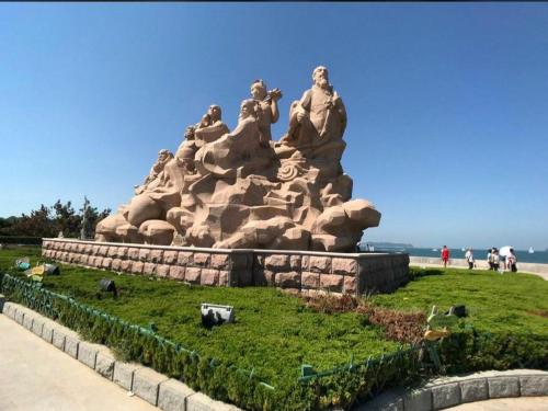 a statue on the side of the beach at 7Days Premium Yantai Penglai New Bus Station Branch in Penglai