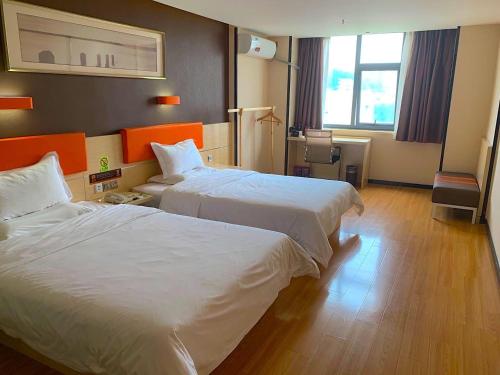 מיטה או מיטות בחדר ב-7Days Premium Shenzhen Songgang Yanchuan Branch