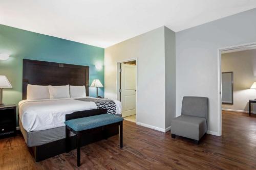 a bedroom with a bed and a chair in it at La Quinta by Wyndham PCB Pier Park area in Panama City Beach