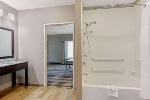 a bathroom with a shower and a tub at La Quinta by Wyndham Paducah in Paducah