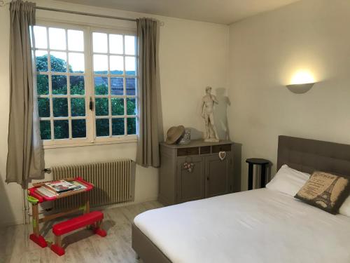 une chambre avec un lit et une fenêtre dans l'établissement Les portes du vignoble, à Nuits-Saint-Georges