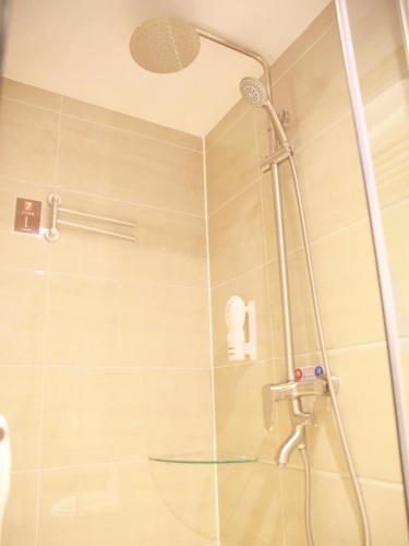 a shower with a glass door in a bathroom at 7Days Premium Beijing Dongba Branch in Beijing