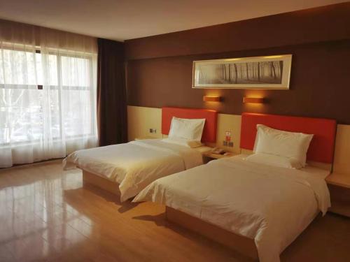 Ένα ή περισσότερα κρεβάτια σε δωμάτιο στο 7Days Premium Beijing Dongba Branch