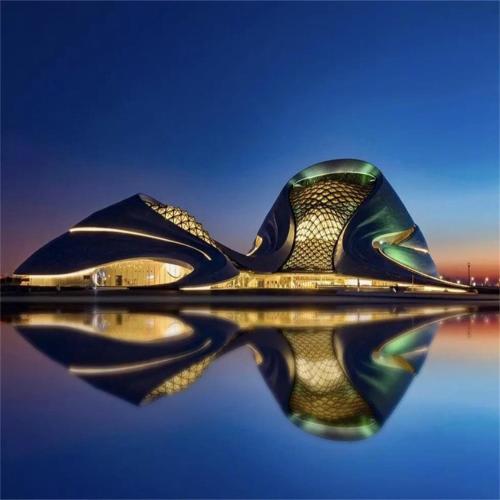 a building with its reflection in the water at 7Days Premium Harbin Xuefu Road Branch in Harbin