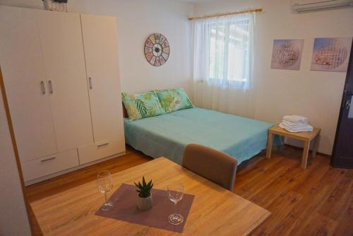 Habitación pequeña con cama y mesa en Apartment Denis en Rovinj