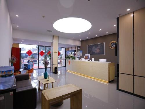 a lobby of a store with a couch and a table at 7Days Premium Tangshan Xiaoshan People's Hospital Branch in Tangshan