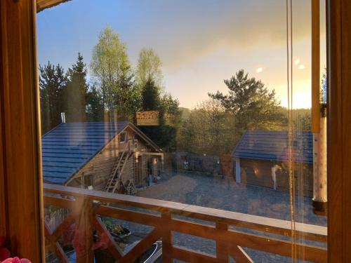 a view from a window of a cabin at Zakątek RąbÓwka Dom Ryby Bania in Rąb