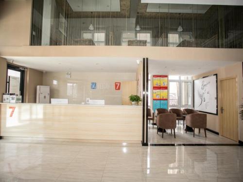 a dining room with a table and chairs in a building at 7Days Premium Chengde University City High Speed Rail Station Branch in Chengde