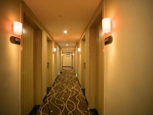 a corridor of a hotel with a long hallway at 7Days Premium Chengde University City High Speed Rail Station Branch in Chengde