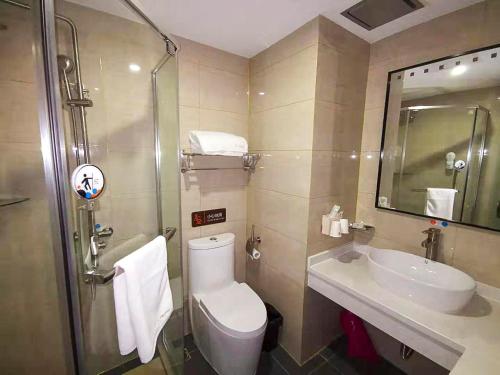 a bathroom with a toilet and a sink at 7Days Premium Chengde University City High Speed Rail Station Branch in Chengde