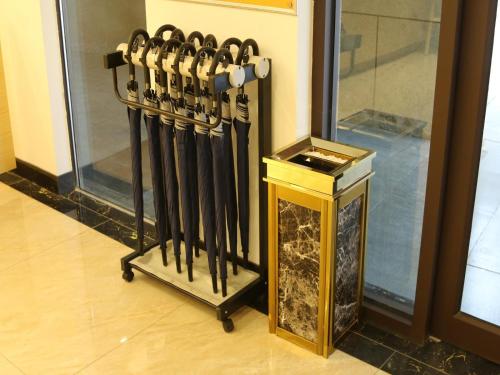 a group of baseball bats leaning against a wall at 7Days Premium Jinan West Railway Station Branch in Jinan