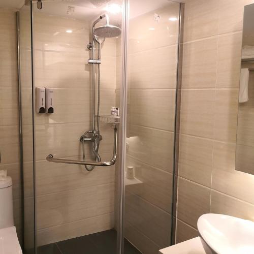 y baño con ducha y puerta de cristal. en 7Days Premium Ji'an Taihe Gongnongbing Avenue Branch, en Ji'an