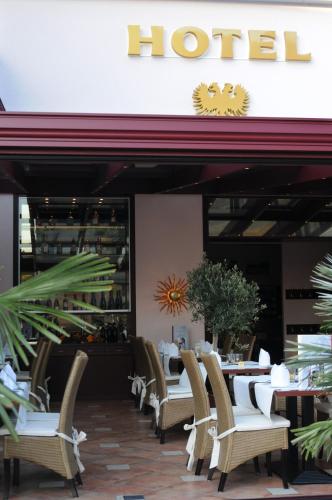 a restaurant with chairs and tables in front of a hotel at Hotel Restaurant Doppeladler in Rees
