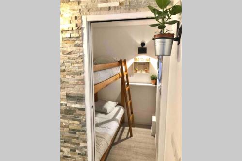 a small room with a bunk bed and a mirror at Grand studio cabine 30 m² centre ville, refait à neuf pour vous ! Climatisé in La Grande Motte
