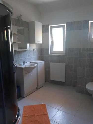 a small kitchen with a sink and a window at Penzion V Maštali in Kněževes