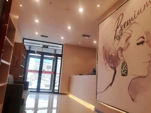 a lobby of a store with a large picture of a woman at 7Days Premium Lanzhou New District Airport Branch in Lanzhou