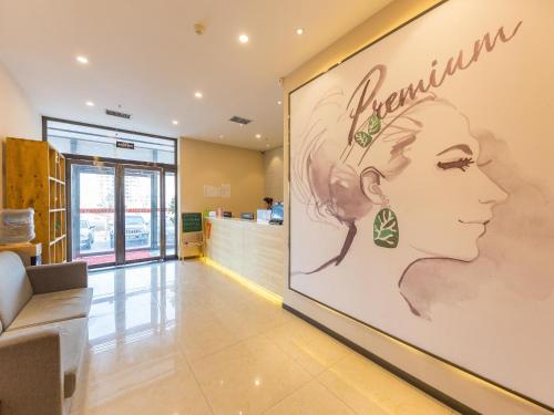 a store lobby with a large poster of a woman at 7Days Premium Lanzhou New District Airport Branch in Lanzhou