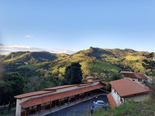 an aerial view of a building with a mountain at Pousada Colonetti in Lindóia