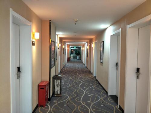 a hallway of a hotel with a long corridor at 7Days Premium Xining Bayi East Road Tuanjie Bridge Branch in Xining