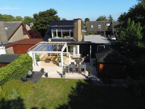 an aerial view of a house with a conservatory at Lake house 21 relax accommodation iR Sauna in Warmond