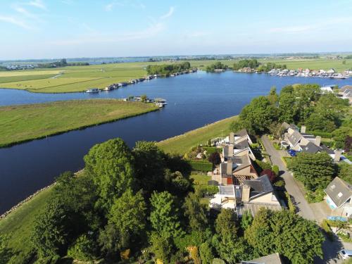 an aerial view of a village on the river at Lake house 21 relax accommodation iR Sauna in Warmond