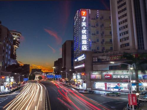 a busy city street at night with cars at 7 Days Premium Jiangmen Diwang Plaza Branch in Jiangmen