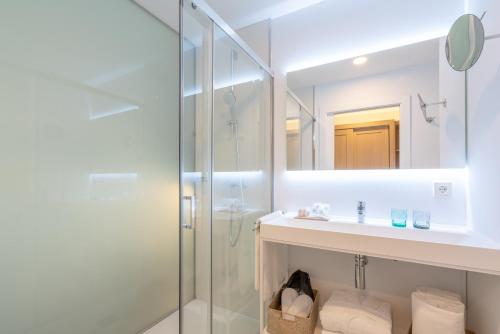 a bathroom with a shower and a sink and a mirror at Soller Plaza in Sóller