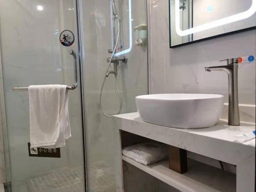 a bathroom with a sink and a shower at 7Days Premium Guangzhou Guangyuan Coach Station Branch in Guangzhou