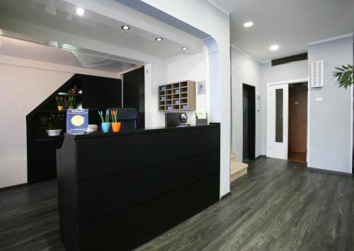 a lobby with a black counter in a room at Hotel Magenta in Florence