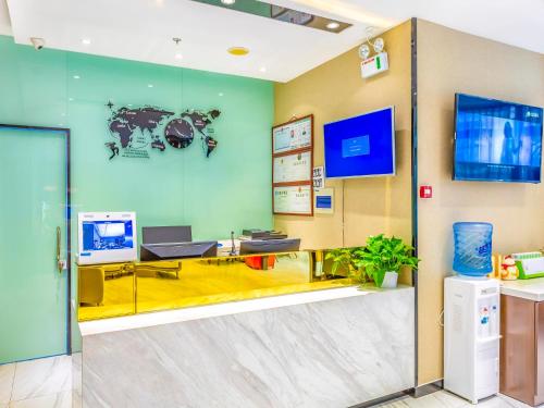 an office with a desk and a computer on a wall at 7Days Premium Beijing Zhongguancun Renmin University Suzhou Street Subway Station Branch in Beijing